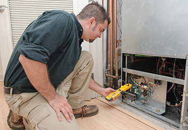 Guy servicing a business heating system