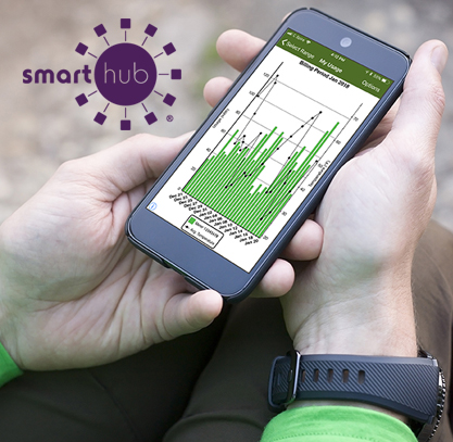 Hands holding cell phone with SmartHub app to advertise use tracking