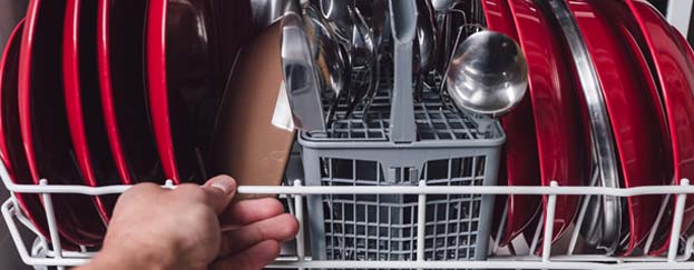 Person pulling dishwasher basket