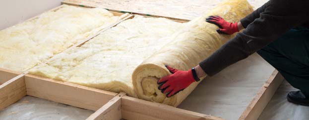 Person rolling insulation