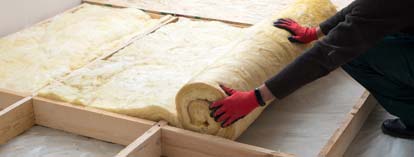 Person rolling insulation