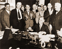 President Franklin D. Roosevelt at his desk with businessmen