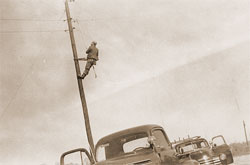 Lineman working from pole in SRE's early years