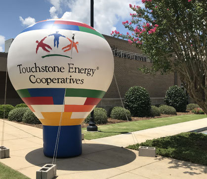 Touchstone Energy mini hot air balloon in front of Lucedale office