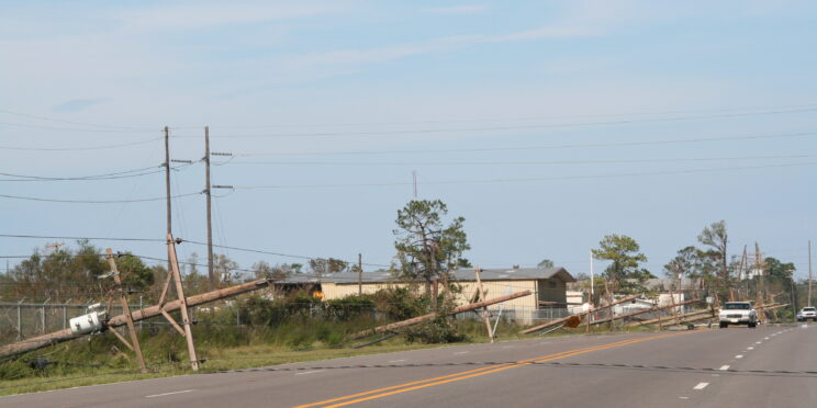 Power poles leaning near the road after Hurricane Katrina
