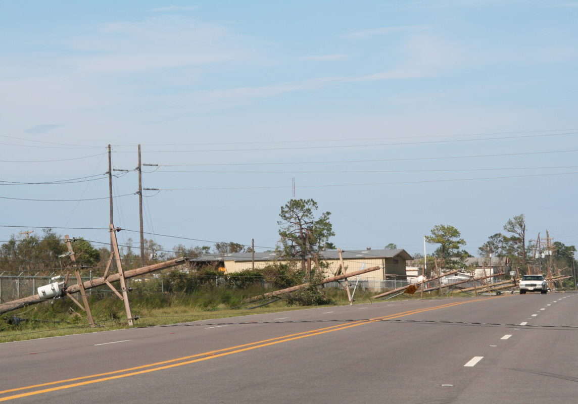 Power poles leaning near the road after Hurricane Katrina