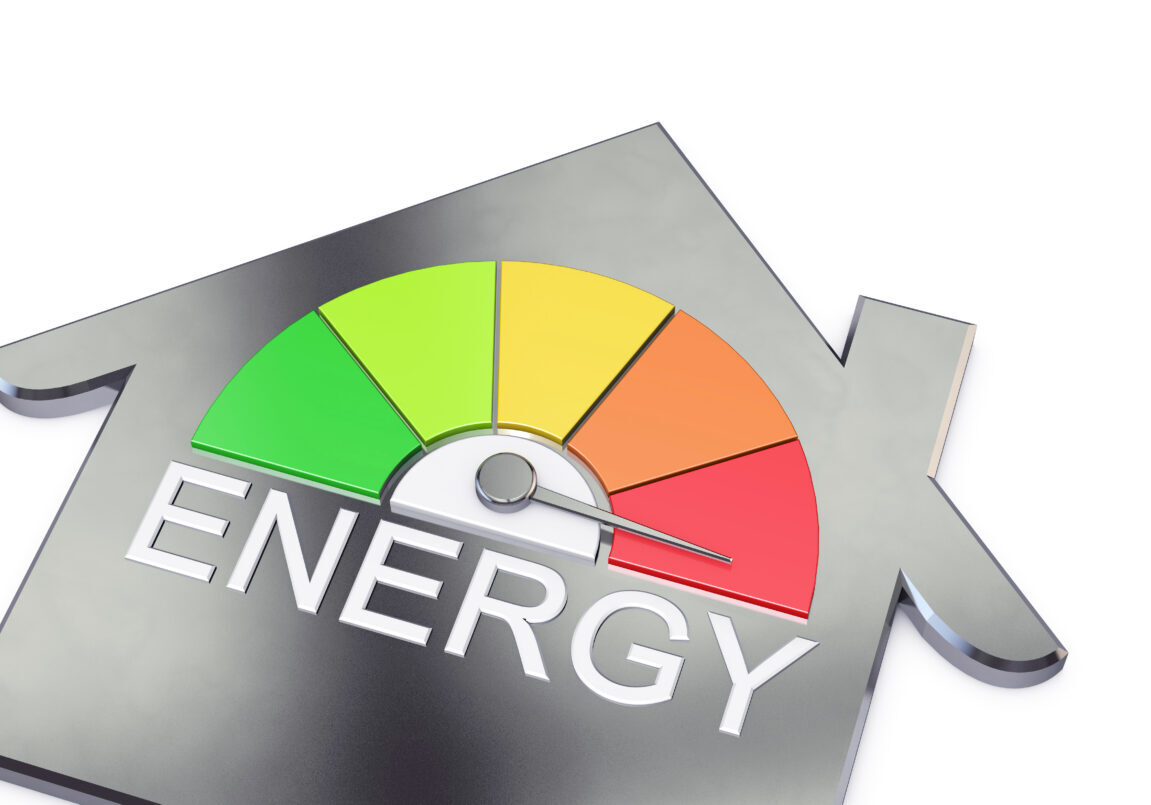 A 3D render of a housing dial pointing into the red. There are 5 coloured sections on the chart, the first segment on the left is green, second is yellow, third is light orange, fourth is orange and the fifth is red. In the centre of the gauge is a metal indicator that is pointing directly to the red section. Below the dial is written energy